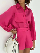 Vooraanzicht fuchsia Nolani blouse met bijpassende shorts
