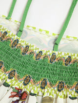 Flora zomerjurk met shirred taille en kleurrijke print
