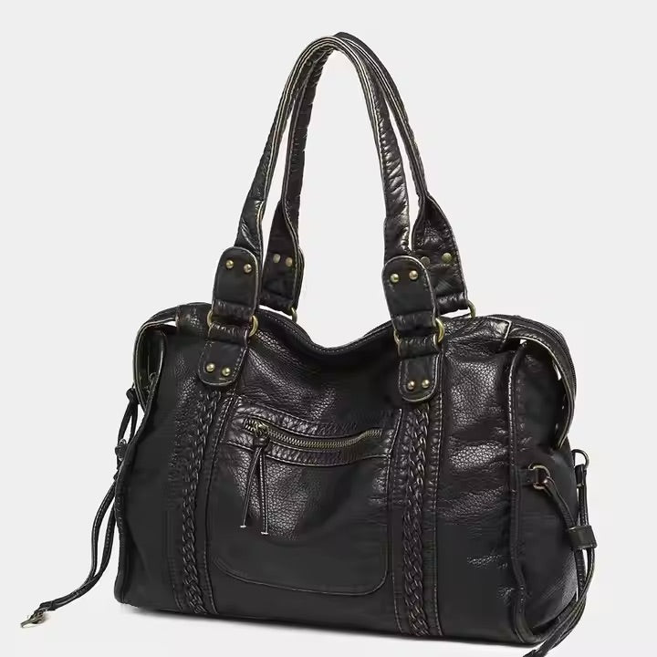 zwarte vintage schoudertas van PU leer met metalen details en dubbele handgrepen
