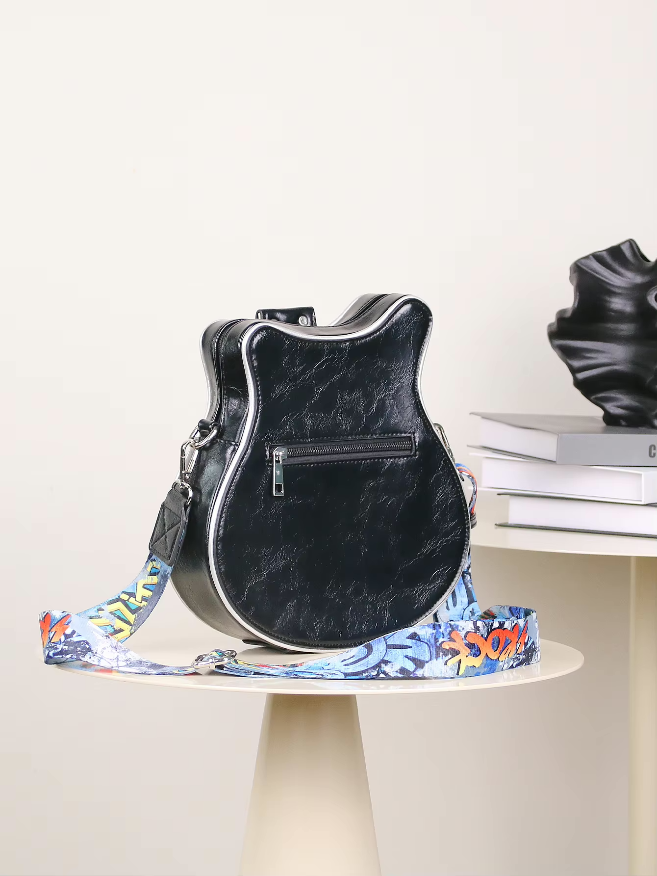 Zwarte gitaarvormige tas met wit en blauw bloemenband