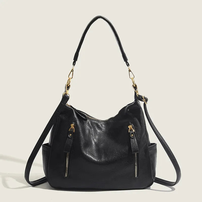 zwarte leren hobo schoudertas met gouden hardware en afneembare band
