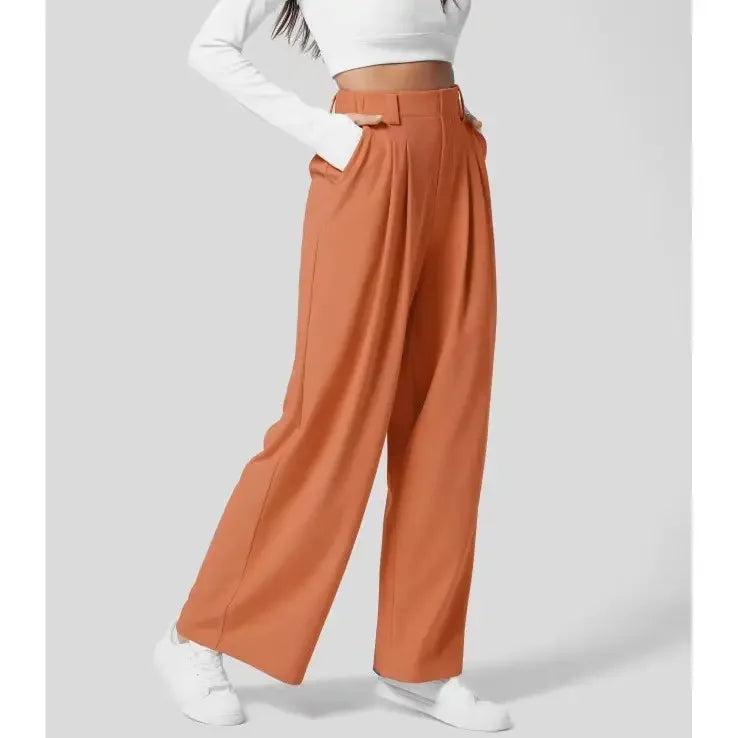 Faye Wide Leg Pantalon in oranje met hoge taille, comfortabele pasvorm en elegante wijde pijpen – ideaal voor werk en vrije tijd.