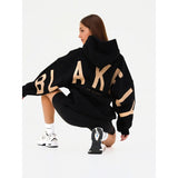 Blayen Oversized Sweatshirt Damen Schwarz mit großem Beigem Backprint – Talaine