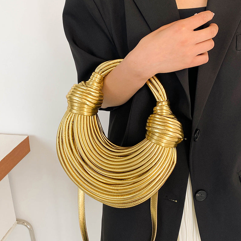 Unieke golvende tas in champagnekleur, perfect voor dagelijkse en feestelijke outfits