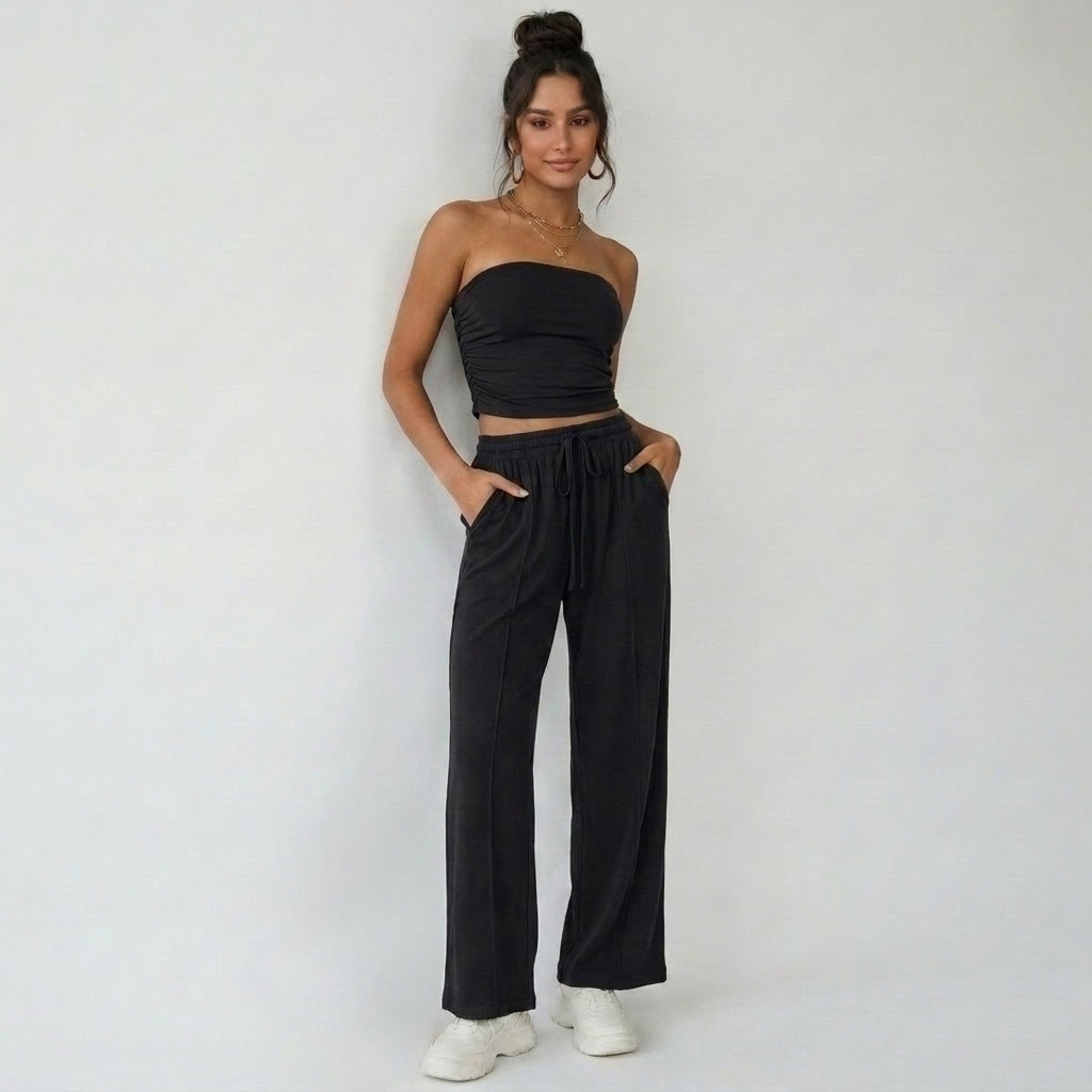 Elvani Lounge-Set Damen in Schwarz – minimalistische Frontansicht, Bandeau-Top mit Wide-Leg-Hose, Hände in den Taschen