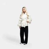 Aurora Faux Fur Coat in beige, gestyled met zwarte wijde broek
